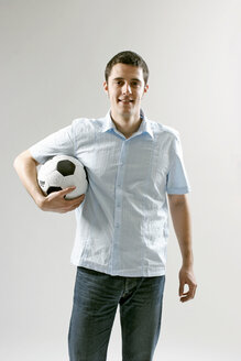 Young man holding soccer ball - LDF00030