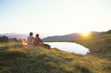 Two people watching sunset - HH00092