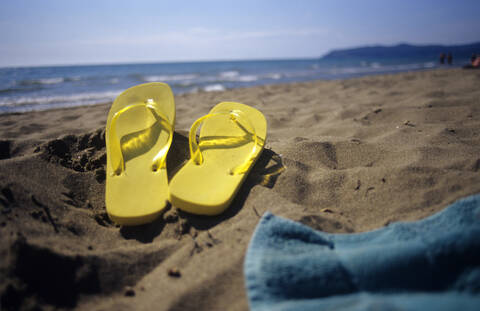 Flip Flops im Sand am Strand, lizenzfreies Stockfoto