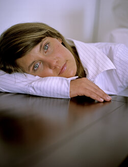 Woman laying head on table, close up - DK00051