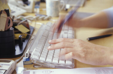 Man using computer, close-up (blurred motion) - 00611MS