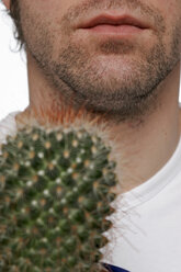 Young man holding cactus plant - LDF00007