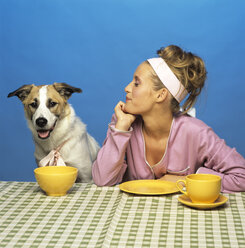 Woman watching dog at table - JLF00014