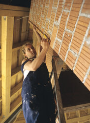 Carpenter measuring wall - PEF00346