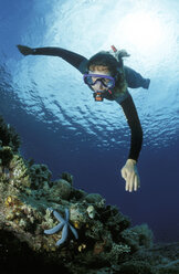 Diver over corals - GN00540