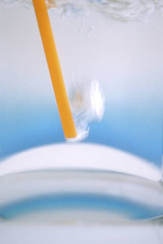 Straw in waterglass, blurred image stock photo