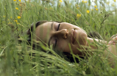 Woman lying and sleeping in meadow - LDF00078