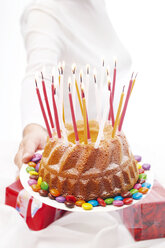 Woman holding out birthday cake with candles - 02507CS-U