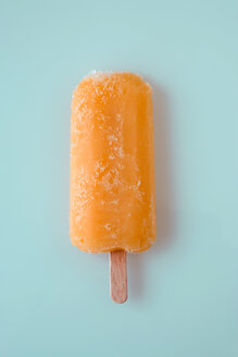 Orange ice lolly stick, overhead view - MNF00080