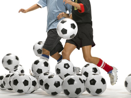 Two kids kicking footballs - LMF00145