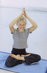 Girl (8-9) doing yoga - CRF00612