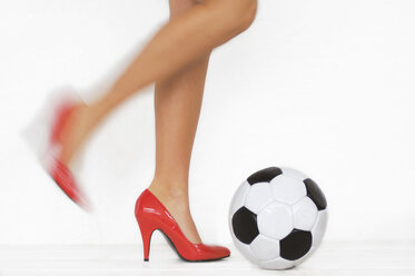 Woman with red high heels kicking a soccer ball, detail - LRF00002