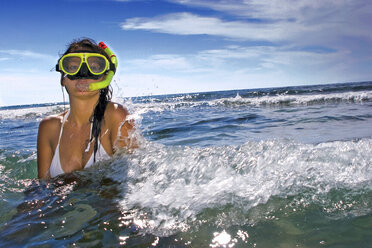 Woman wearing snorkel mask in sea, portrait - LDF00129