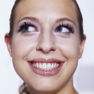 Young woman smiling, looking up - JLF00058