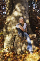 Young girl sitting under a tree - WEPF00027
