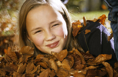 Girl (10-11) with autumn leaves, portrait - WEPF00010
