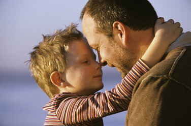 Son (6-9) and father touching noses, close up - WEPF00009