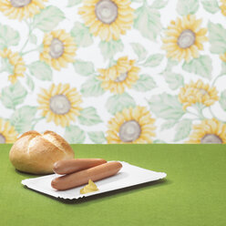 Wiener with mustard and bread roll on table - CHKF00021