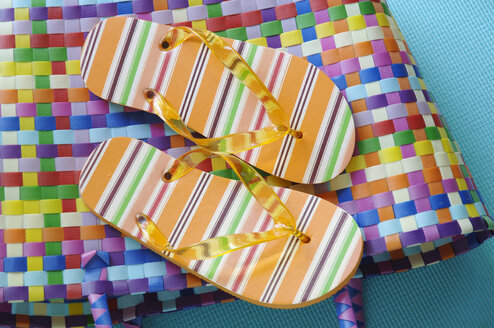 Flip flops on coloured bag - ASF01440