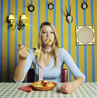 Young woman eating french fries - JLF00067