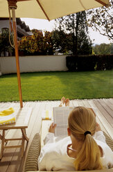 Woman reading on terrace, rear view - MSF01758