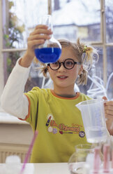 Girl (8-9) in chemical lab, smiling - WESTF00027