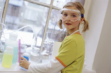 Girl (8-9) in chemical lab wearing protective goggles, portrait - WESTF00024