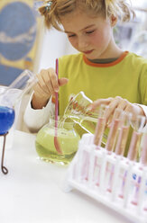 Girl (8-9) in chemical lab with test tubes - WESTF00014