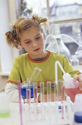 Girl (8-9) doing chemistry experiment - WESTF00013