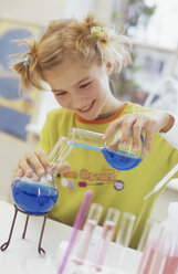 Girl (8-9) in chemical lab, smiling - WESTF00012