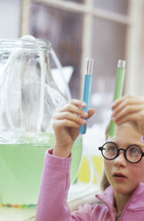 Girl (8-9) holding test tubes in lab - WESTF00010