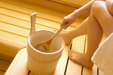 Woman with bucket in sauna - HHF00273