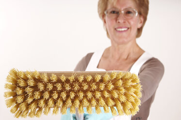 Mature woman holding broom - 00031LRH-U