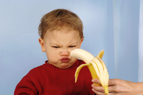 Boy (2-3) rejecting banana - CRF00856