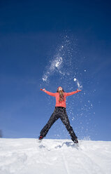Woman jumping in snow - WESTF00183