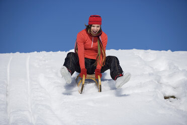 Young woman riding sledge - WESTF00177