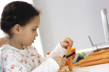 Young girl peeling carrots - WESTF00213