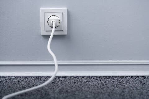 Electric plug in outlet stock photo