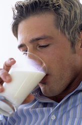 Junger Mann trinkt ein Glas Milch, Nahaufnahme - WESTF00295