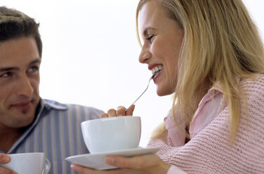 Couple drinking coffee and tea, close-up, smiling - WESTF00277