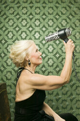 Senior woman with hair-dryer - WEST00360