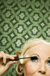 Senior woman applying mascara - WEST00357