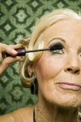 Senior woman applying mascara - WEST00356