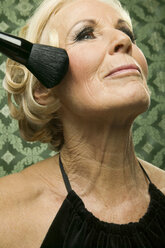 Senior woman with make up brush - WEST00354