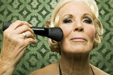 Senior woman with make up brush - WEST00353