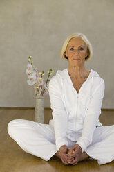 Senior woman exercising in yoga position, portrait - WESTF00645