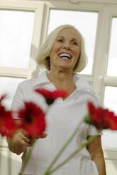 Senior woman laughing, looking away, portrait - WESTF00634