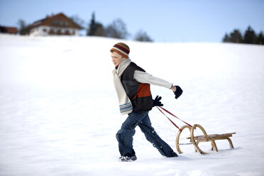 Austria, boy (12-13) pulling sledge in snow, side view - WESTF00706