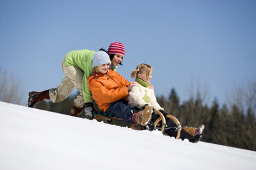 Three children on sledge - WESTF00692