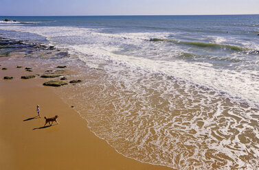 Portugal, Algarve, boy (6-7) with dog on beach, elevated view - MSF01919